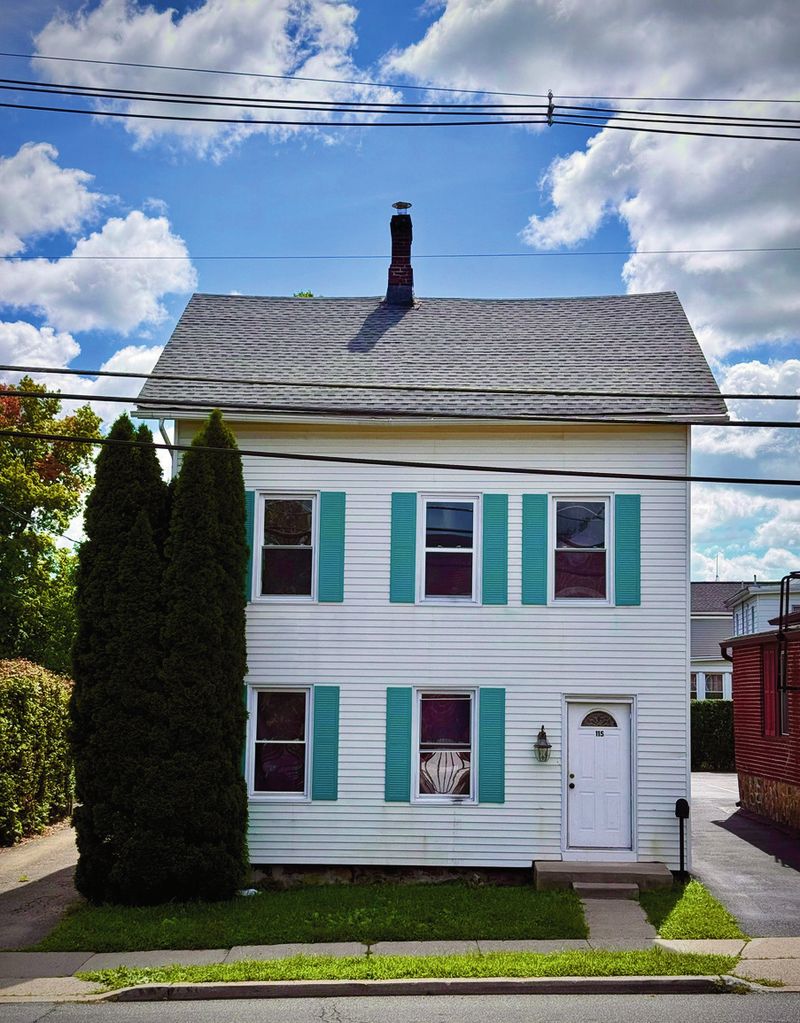 White colonial with teal shutters
